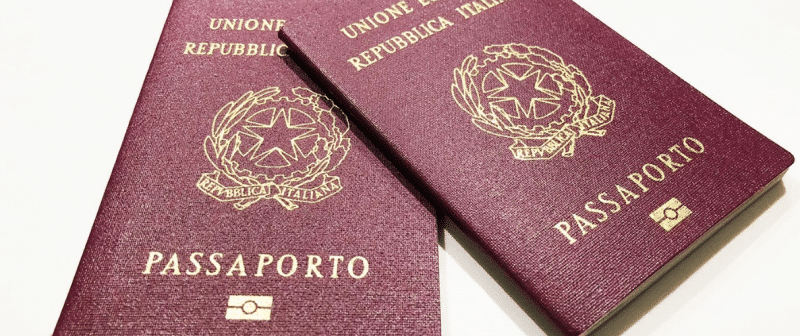 two italian passports laid on top of each other