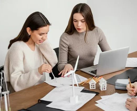 Property acquisition consultants reviewing development documents and house models for Manchester developers