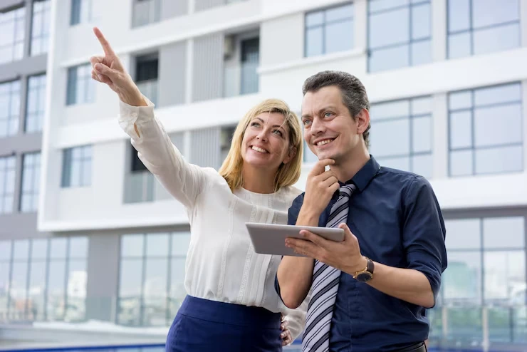 Property investment planning consultation with couple reviewing market opportunities and goals alignment