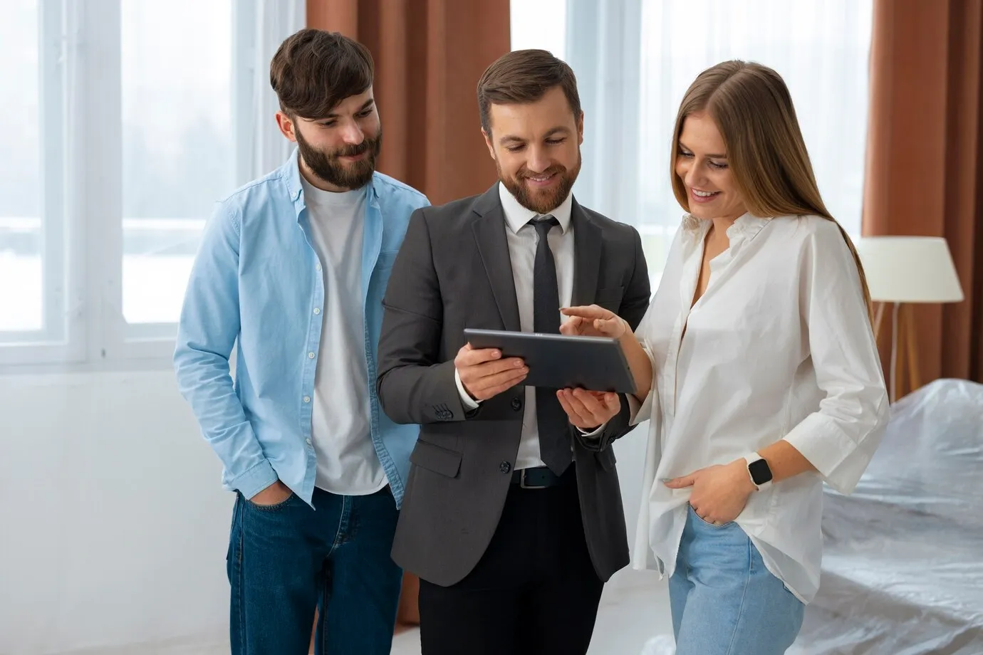 Real estate advisor consulting with clients using tablet for investment property analysis