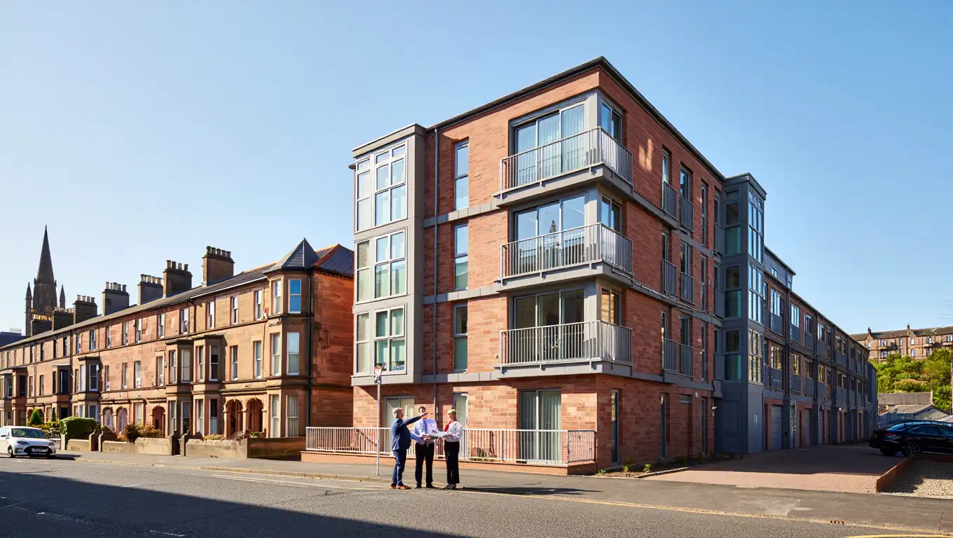 Residential property sourcing consultation outside modern Glasgow apartment building