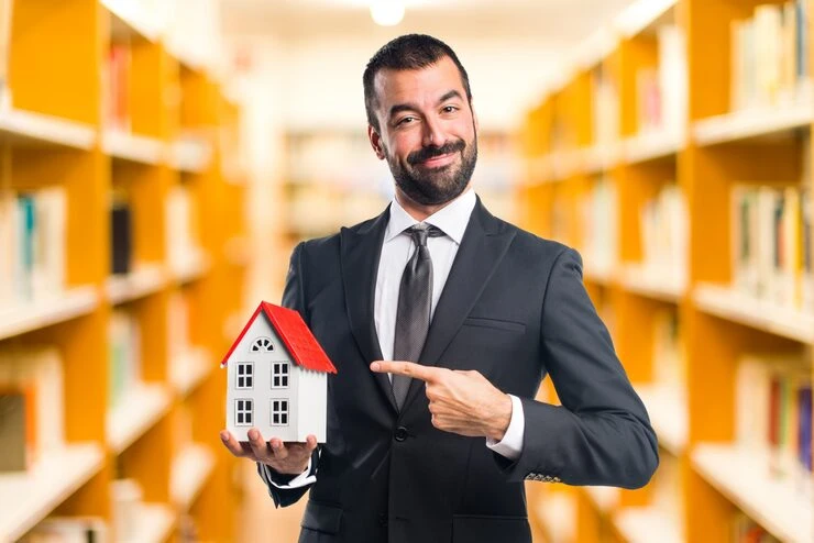 Professional property sourcer presenting house model showcasing expertise in Leeds property sourcing services