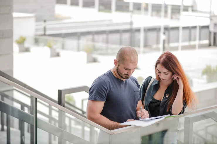 Real estate investor reviewing distressed property documents in office with floor plans layout
