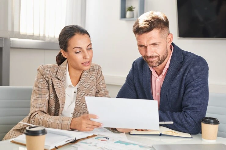 Real estate finance advisor reviewing funding plan and cost structuring for property investment file