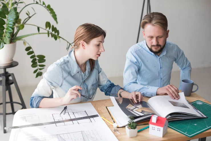 Real estate advisor reviewing renovation plans and repositioning strategy for property assets