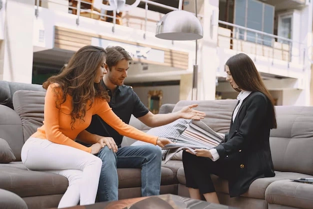 Agent presenting property documents to couple