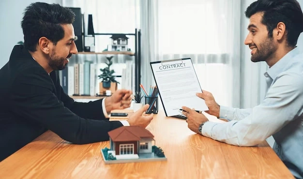 Agent presenting property contract to smiling client
