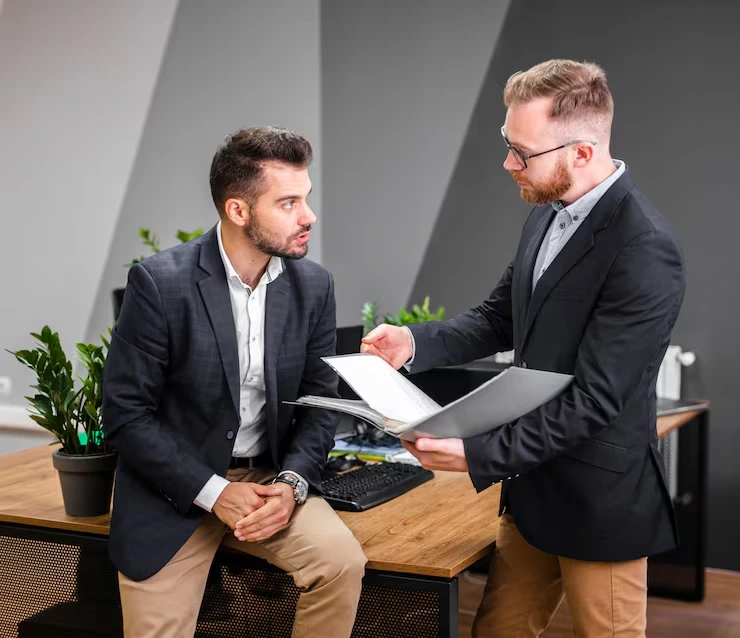 Trusted real estate advisor reviewing negotiation and acquisition support documents for property deal file